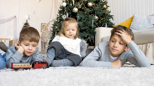 Happy friends sitting on floor