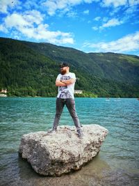 Full length of young man standing on rock