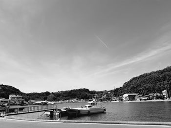 Boats moored on sea against sky