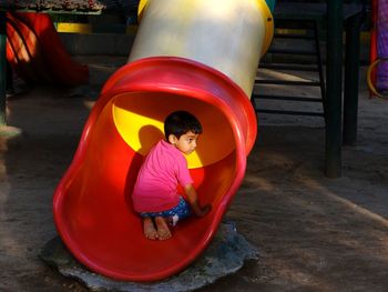Rear view of boy playing at playground