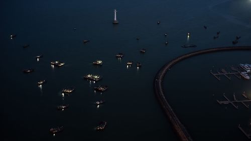 High angle view of boats in sea at dusk