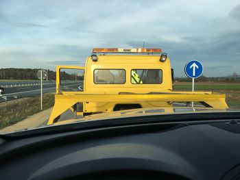 Yellow car against sky