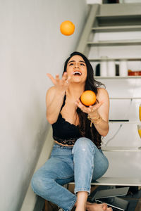 Full length of woman holding ice cream