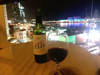 Close-up of wine bottles on table at night