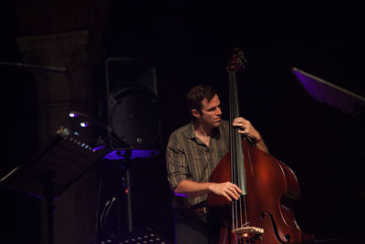 Young man playing music concert