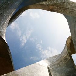 Low angle view of building against cloudy sky