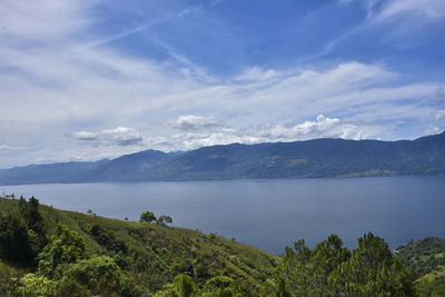 Scenic view of lake and mountains against sky