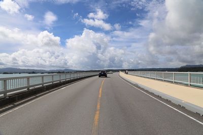 Road by sea against sky