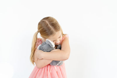 Cute girl standing against white background