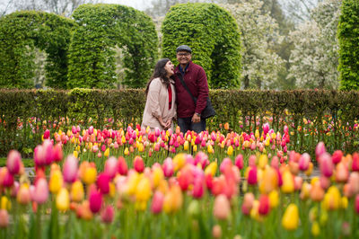 Rear view of couple standing in field