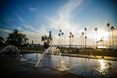 Scenic view of swimming pool against sky at sunset