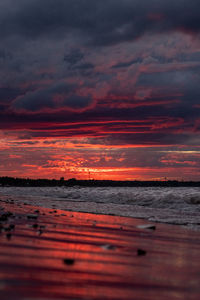 Scenic view of sea against orange sky