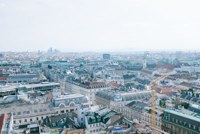 High angle view of city buildings against clear sky