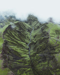 Close-up of green land against clear sky