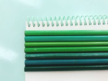 Close-up of pencils on spiral notebook