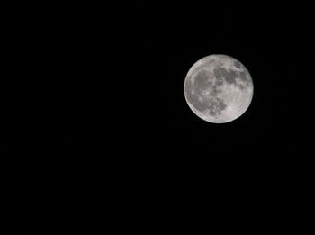 Low angle view of moon against clear sky at night