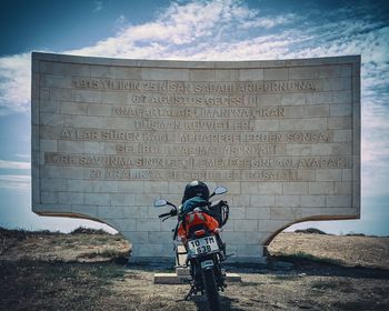 Text on bicycle against wall