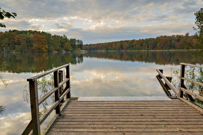 Pier over lake against sky