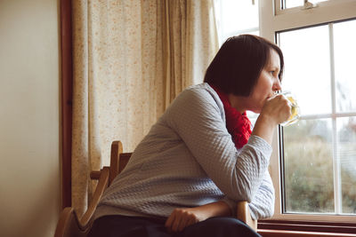 Side view of woman at home