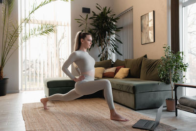 Woman sitting on sofa at home