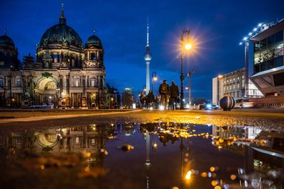 Reflection of buildings in city at night