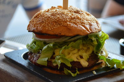 Close-up of fresh burger served on table