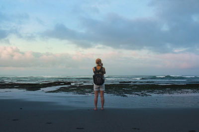 A woman waiting for sunrise at canggu beach, bali, indonesia.