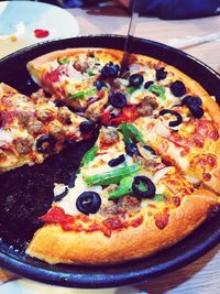 Close-up of pizza served on table