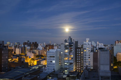 High angle view of illuminated buildings against sky in city