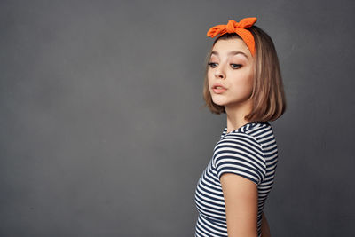 Portrait of beautiful young woman against white background