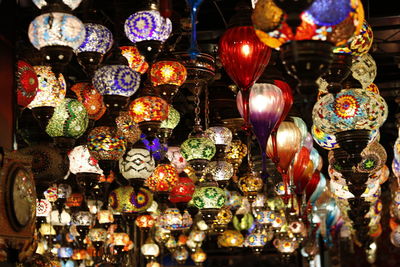 Close-up of illuminated lanterns hanging for sale in store