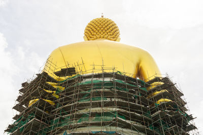 The back of the big golden buddha statue is under construction, in wat paknam bhasicharoen, thailand