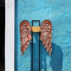 Graffiti on blue door of building