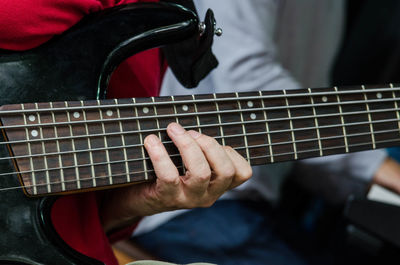 Cropped hands of man playing guitar