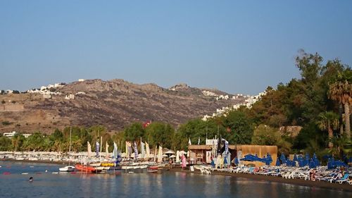 Boats in lake against clear sky