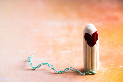 Close-up of tampon with blood on table