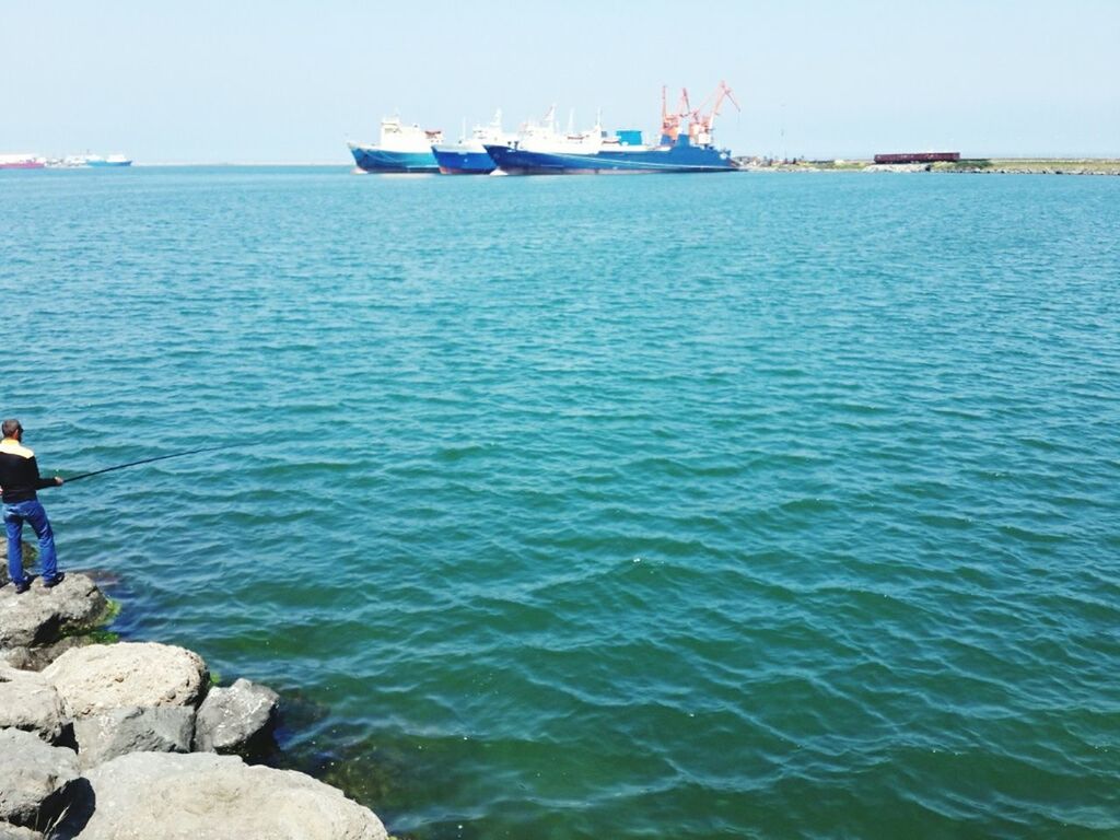 water, sea, nautical vessel, transportation, blue, clear sky, mode of transport, rippled, scenics, men, boat, horizon over water, tranquility, tranquil scene, lifestyles, leisure activity, beauty in nature, nature