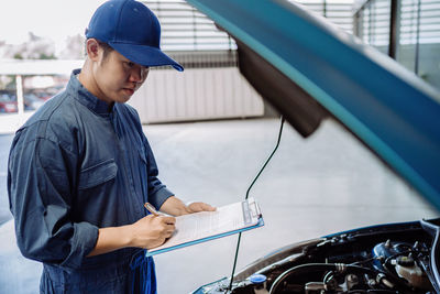 Mechanic examining car in garage