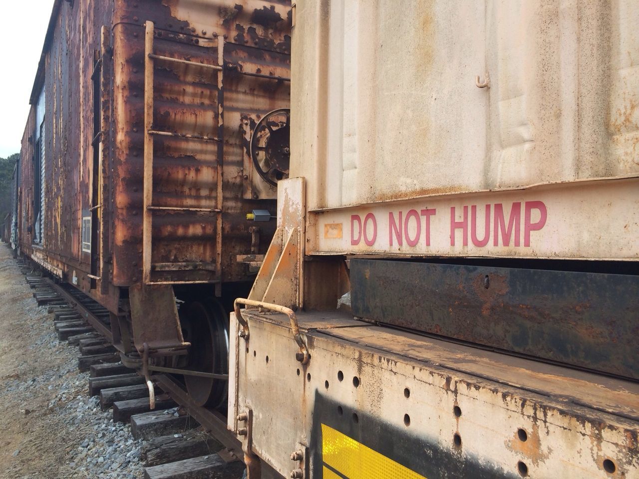 architecture, building exterior, built structure, text, western script, transportation, city, communication, railroad track, building, rail transportation, day, public transportation, non-western script, window, mode of transport, outdoors, information sign, no people, train - vehicle