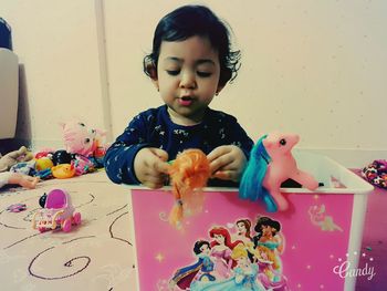 Cute girl playing on table at home