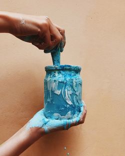 Close-up of woman holding blue hand