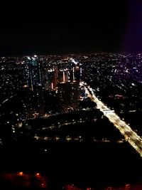 Aerial view of city lit up at night