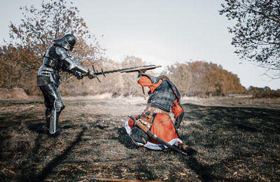 Full length of warriors fighting on field