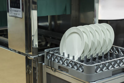 Close-up of plates in rack in factory