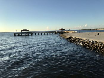 Pier over sea against clear sky