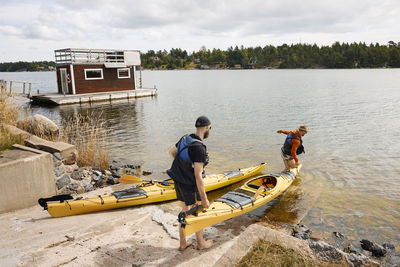 View of men putting kayaks on water