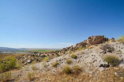 Scenic view of landscape against blue sky