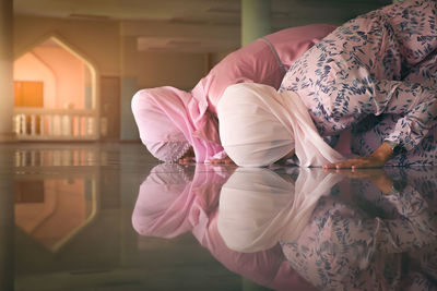 Rear view of woman holding pink umbrella