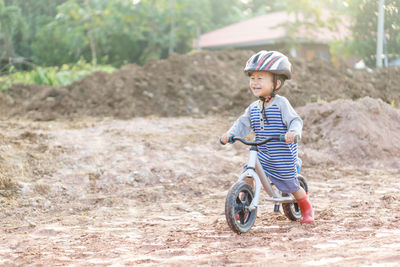 Cute boy riding bicycle on dirt
