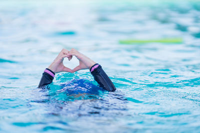 Low section of woman swimming in pool